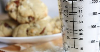 clear glass measuring cup on white ceramic plate